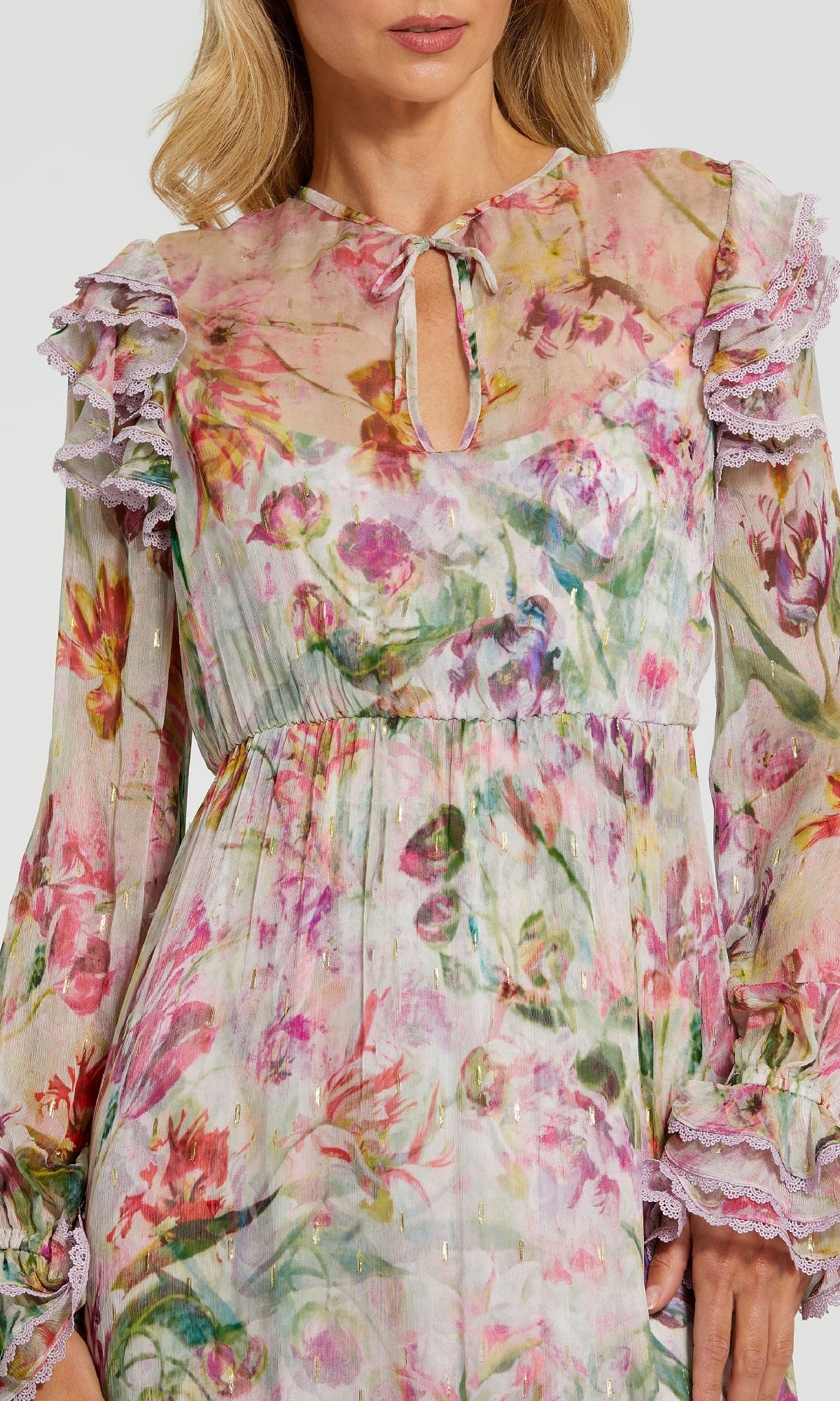 A woman wears the Midi Print Wedding Guest Dress: Mac Duggal 8102, a sheer long sleeve floral dress with ruffled shoulders, lace trim, keyhole neckline, and gathered waistโideal as a stylish midi party dress.